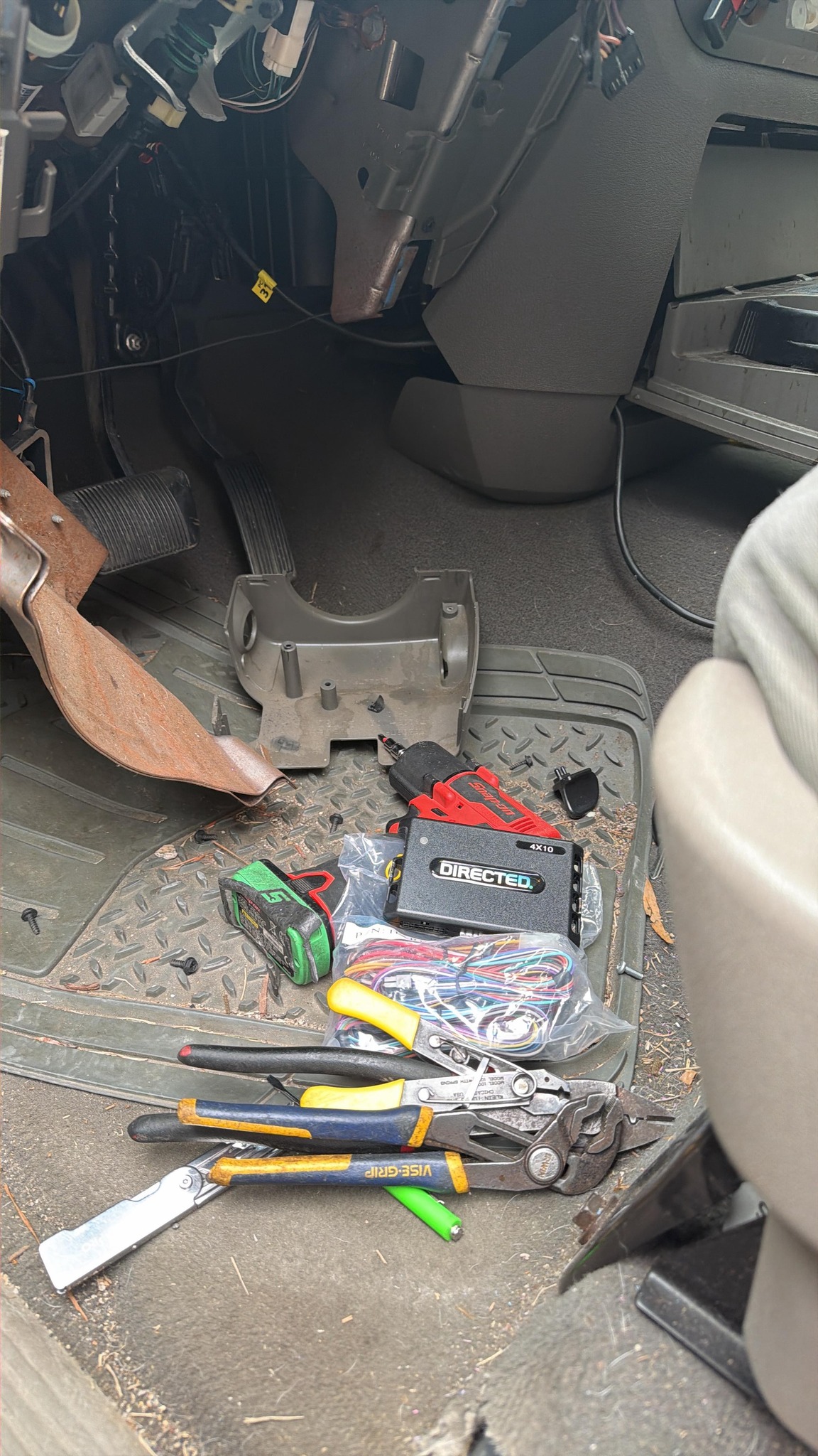 Install tools, wiring harness and Directed module laid out in a vehicle footwell